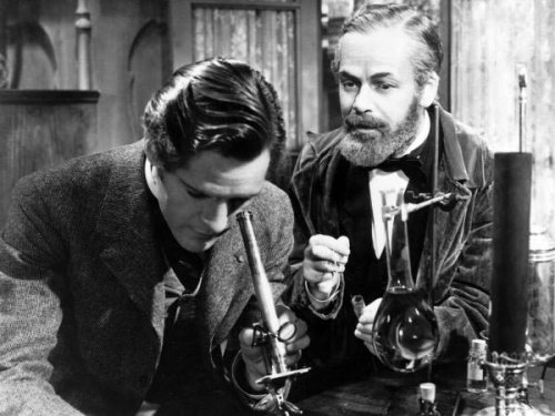 Paul Muni (right) as Louis Pasteur